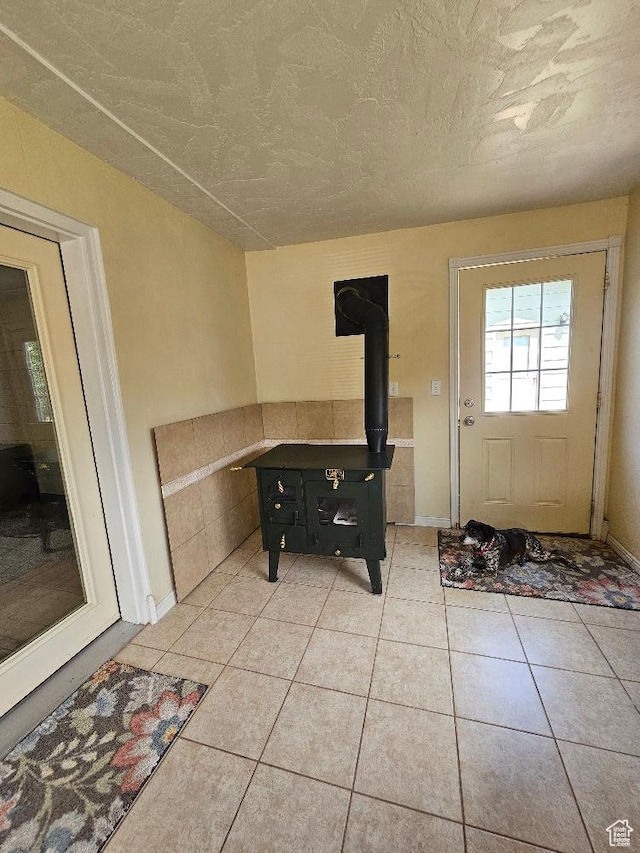 675 W 3300 N, Vernal, UT 84078 - doorway featuring a wood stove and light tile patterned flooring