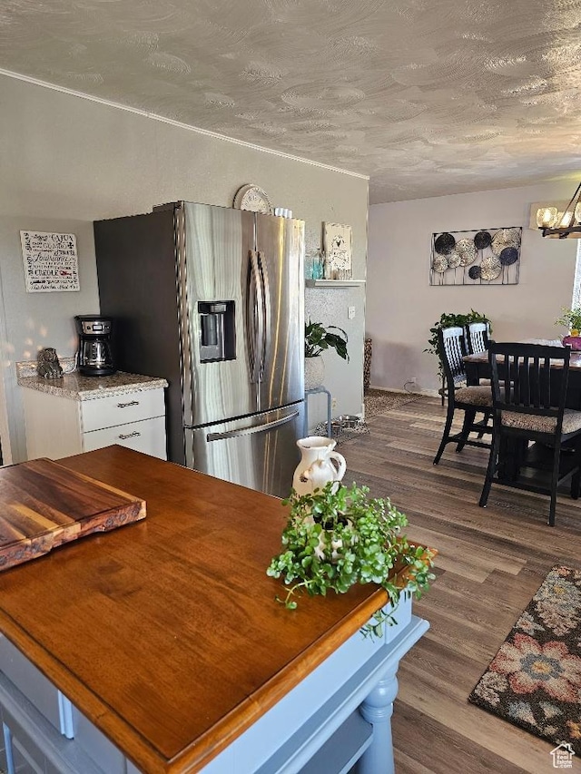 675 W 3300 N, Vernal, UT 84078 - kitchen with stainless steel fridge, a chandelier, white cabinets, dark wood-style flooring, and a textured ceiling