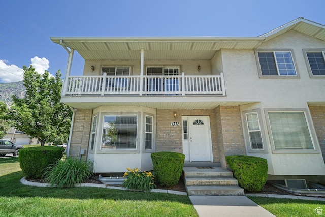 1332 S 1400 E, Provo, UT 84606 - view of property featuring a balcony, stucco siding, and brick siding