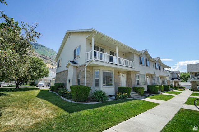 1332 S 1400 E, Provo, UT 84606 - view of property with a balcony, a front yard, stucco siding, a mountain view, and stone siding