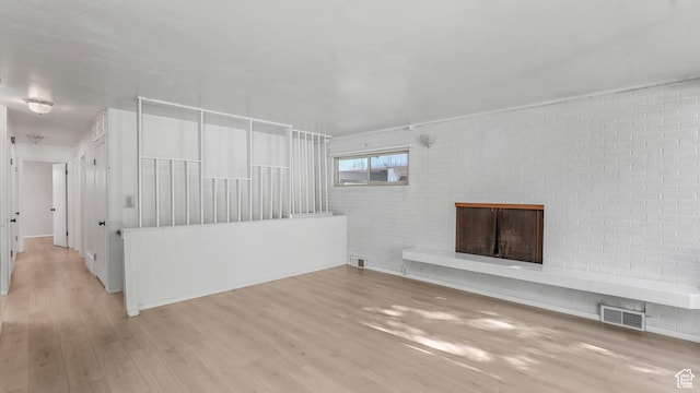 720 N 1200 E, Provo, UT 84606 - unfurnished living room with wood finished floors, a brick fireplace, and brick wall