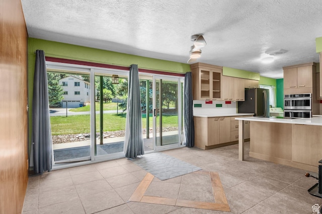 222 S 800 E, Alpine, UT 84004 - kitchen with double oven, light countertops, a textured ceiling, light tile patterned floors, and glass insert cabinets