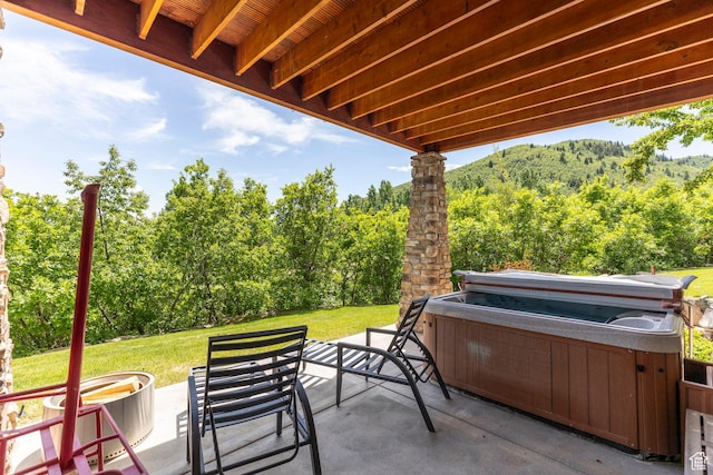 1085 W Links Dr, Midway, UT 84049 - view of patio featuring a hot tub and a wooded view