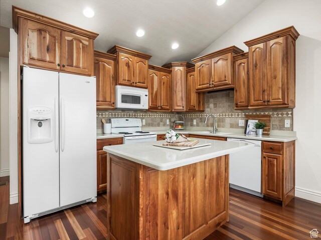 179 S 1060 E, American Fork, UT 84003 - kitchen featuring white appliances, dark wood finished floors, light countertops, tasteful backsplash, and vaulted ceiling