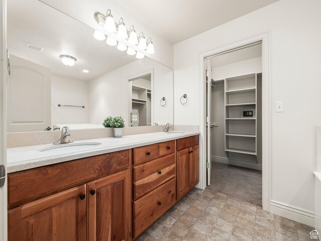 179 S 1060 E, American Fork, UT 84003 - full bathroom with double vanity, a walk in closet, and stone finish floors