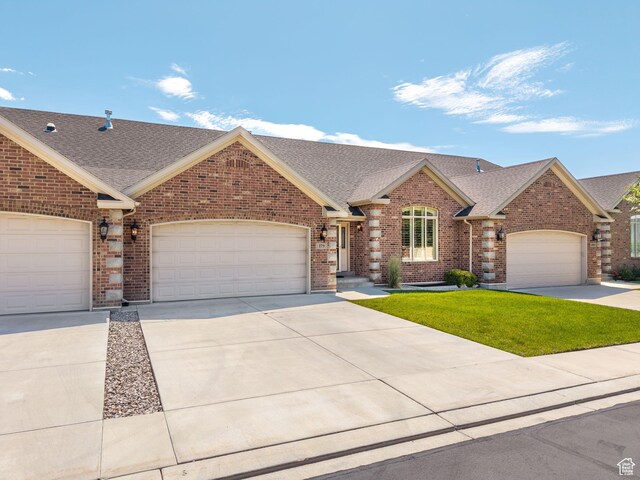 179 S 1060 E, American Fork, UT 84003 - view of front of home with roof with shingles, brick siding, concrete driveway, and an attached garage