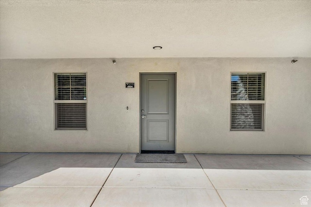 1167 E Telegraph St # A104, Washington, UT 84780 - view of exterior entry featuring a patio area and stucco siding