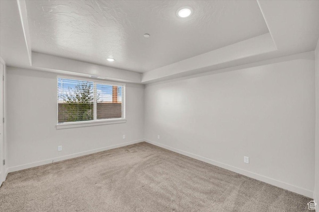 1167 E Telegraph St # A104, Washington, UT 84780 - carpeted empty room featuring a tray ceiling, a textured ceiling, and recessed lighting