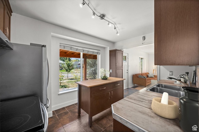 1114 W Briarcliff Ave S, Salt Lake City, UT 84116 - kitchen featuring stainless steel appliances, dark tile patterned flooring, and dark brown cabinets
