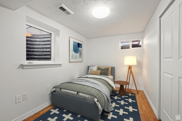 1114 W Briarcliff Ave S, Salt Lake City, UT 84116 - bedroom featuring wood finished floors and a textured ceiling