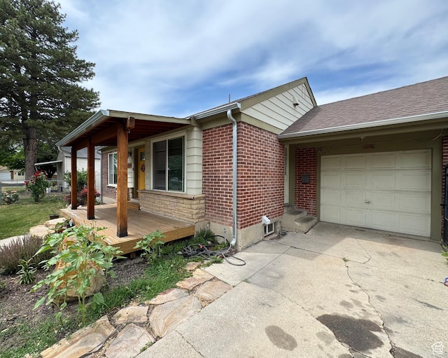 1114 W Briarcliff Ave S, Salt Lake City, UT 84116 - view of home's exterior with an attached garage, concrete driveway, and brick siding