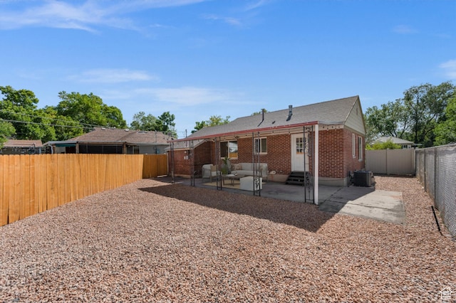 1114 W Briarcliff Ave S, Salt Lake City, UT 84116 - rear view of property with entry steps, a patio area, brick siding, and a fenced backyard