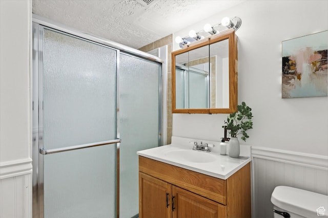 1114 W Briarcliff Ave S, Salt Lake City, UT 84116 - bathroom with vanity, a stall shower, wainscoting, and a textured ceiling