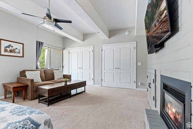 435 Aspen Dr Unit 8, Park City, UT 84098 - bedroom featuring a glass covered fireplace, beam ceiling, light carpet, multiple closets, and a ceiling fan