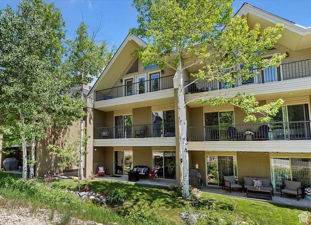 435 Aspen Dr Unit 8, Park City, UT 84098 - rear view of property featuring an outdoor hangout area, a patio area, stucco siding, and a balcony