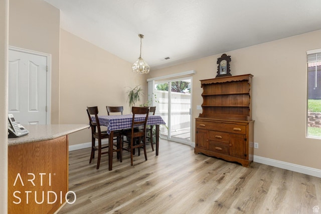524 S Indian Hills Dr Unit 102, St George, UT 84770 - dining area featuring a chandelier, light wood-style floors, and lofted ceiling