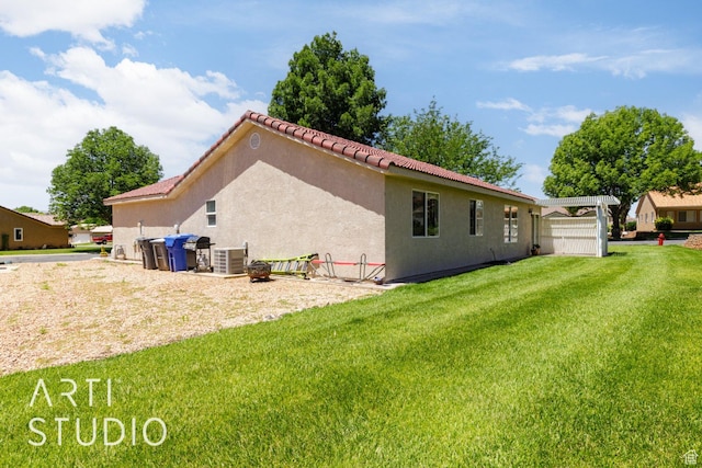 524 S Indian Hills Dr Unit 102, St George, UT 84770 - rear view of property with a lawn, stucco siding, and a tiled roof