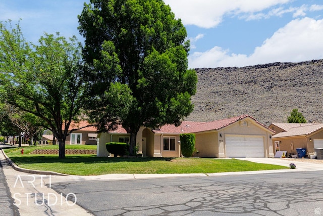 524 S Indian Hills Dr Unit 102, St George, UT 84770 - ranch-style house with an attached garage, stucco siding, concrete driveway, and a front lawn