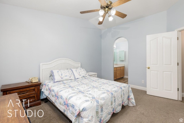 524 S Indian Hills Dr Unit 102, St George, UT 84770 - bedroom with light carpet, arched walkways, vaulted ceiling, connected bathroom, and ceiling fan
