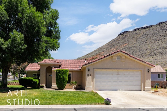 524 S Indian Hills Dr Unit 102, St George, UT 84770 - mediterranean / spanish home featuring driveway, stucco siding, an attached garage, and a front lawn