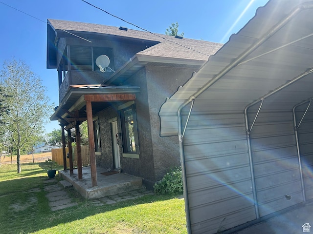 228 S 2 W, Preston, ID 83263 - view of property exterior featuring stucco siding, a shingled roof, and a yard