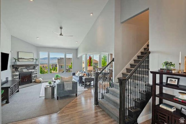 735 W Horizon Dr, Lehi, UT 84043 - stairs featuring high vaulted ceiling, a stone fireplace, a ceiling fan, and wood finished floors