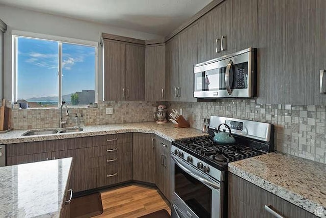 735 W Horizon Dr, Lehi, UT 84043 - kitchen featuring appliances with stainless steel finishes, backsplash, and light stone counters