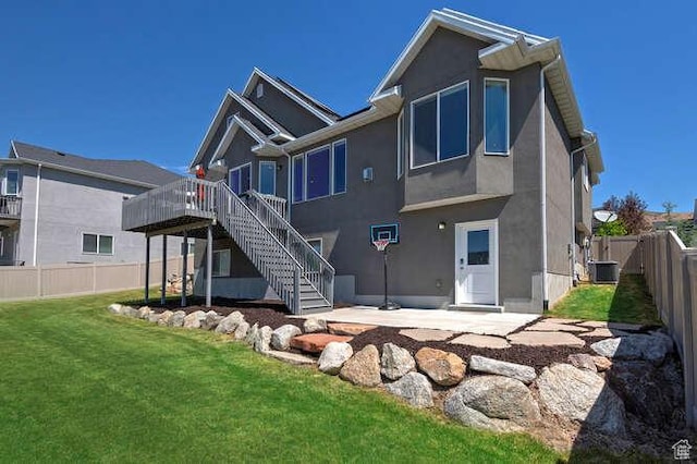 735 W Horizon Dr, Lehi, UT 84043 - rear view of house with stairs, a wooden deck, stucco siding, a fenced backyard, and a patio area