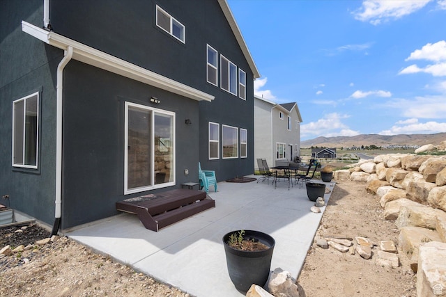 7982 N Bristlecone Rd, Eagle Mountain, UT 84005 - back of house with a mountain view, a patio, and stucco siding