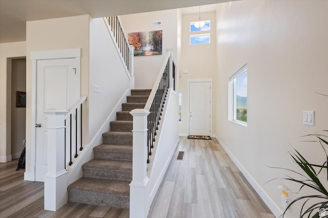 7982 N Bristlecone Rd, Eagle Mountain, UT 84005 - stairs featuring wood finished floors and a high ceiling