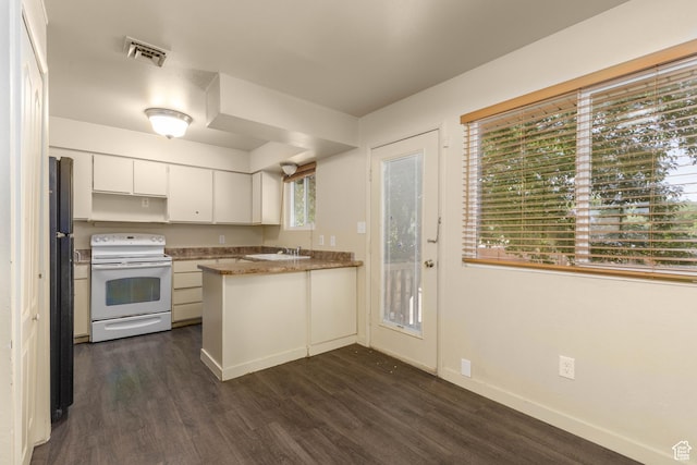 577 W 400 S, Hurricane, UT 84737 - kitchen with electric range, a peninsula, dark wood finished floors, white cabinetry, and freestanding refrigerator