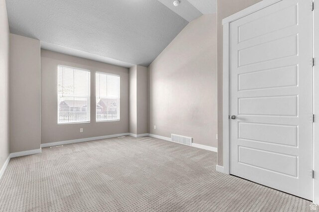 1298 E Salt Creek Peak, Eagle Mountain, UT 84005 - carpeted empty room featuring vaulted ceiling and a textured ceiling