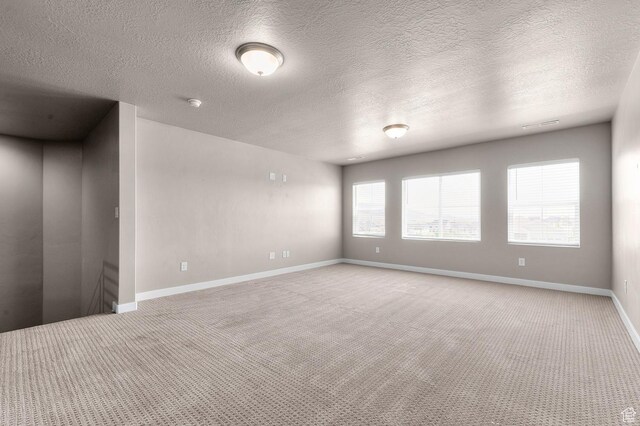 1298 E Salt Creek Peak, Eagle Mountain, UT 84005 - empty room featuring light carpet, a textured ceiling, and a smoke detector