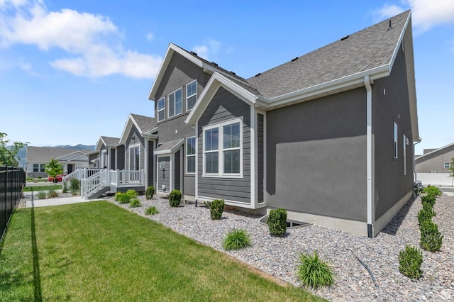 1298 E Salt Creek Peak, Eagle Mountain, UT 84005 - view of side of property with roof with shingles, a residential view, a deck, and stucco siding