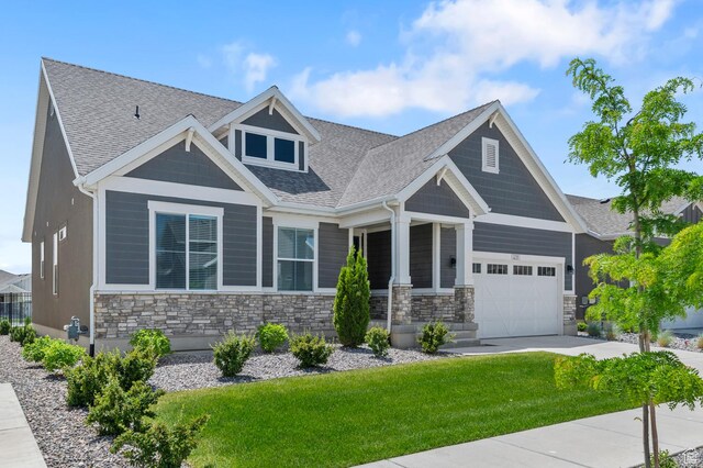 1298 E Salt Creek Peak, Eagle Mountain, UT 84005 - craftsman-style home with stone siding, a garage, a front yard, and a shingled roof