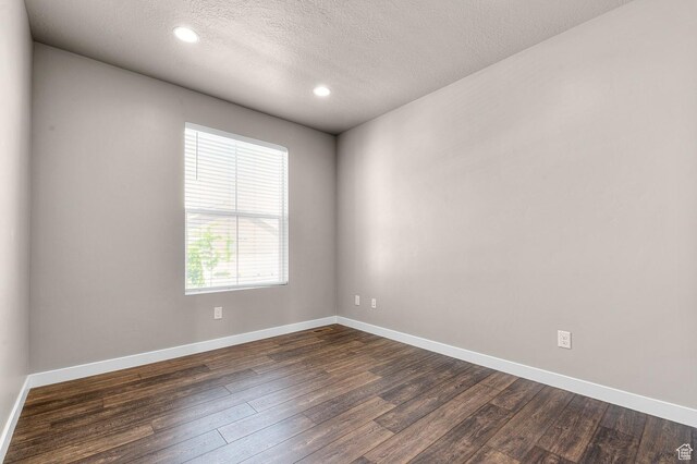 1298 E Salt Creek Peak, Eagle Mountain, UT 84005 - unfurnished room with dark wood-type flooring, a textured ceiling, and recessed lighting
