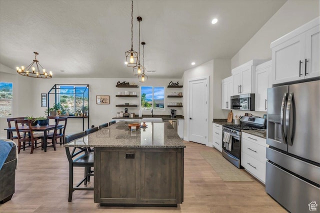 992 S Mulberry Dr, Toquerville, UT 84774 - kitchen with stainless steel appliances, open shelves, a center island, white cabinetry, and a breakfast bar area