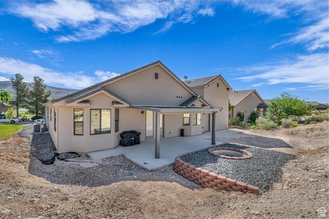 992 S Mulberry Dr, Toquerville, UT 84774 - rear view of property with a fire pit, a patio, and stucco siding