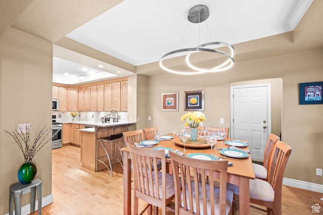 369 E 9th Ave, Salt Lake City, UT 84103 - dining room with a raised ceiling, light wood finished floors, crown molding, a chandelier, and recessed lighting
