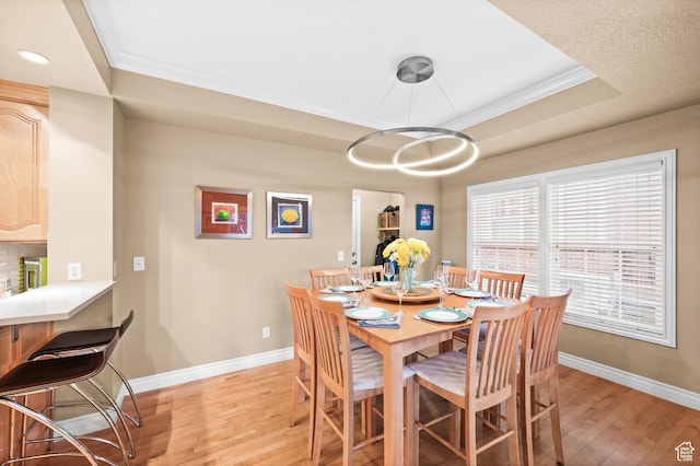 369 E 9th Ave, Salt Lake City, UT 84103 - dining room featuring light wood-style floors, ornamental molding, a tray ceiling, and recessed lighting