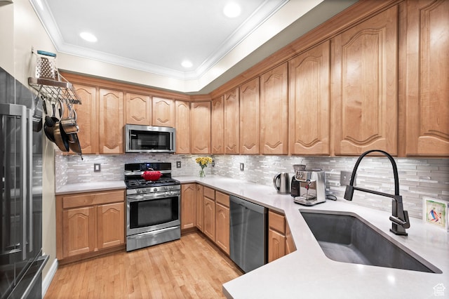 369 E 9th Ave, Salt Lake City, UT 84103 - kitchen featuring stainless steel appliances, light wood-type flooring, light countertops, crown molding, and decorative backsplash