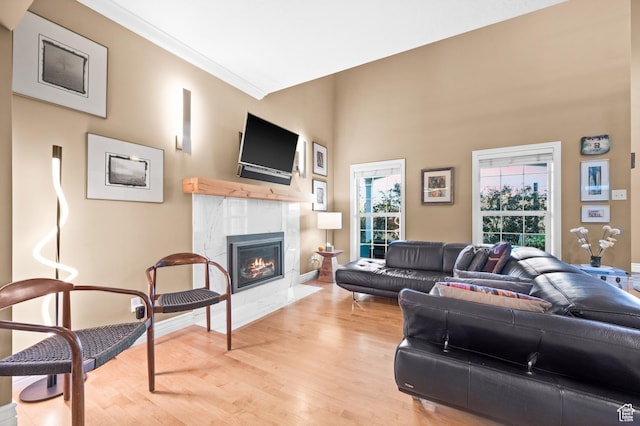 369 E 9th Ave, Salt Lake City, UT 84103 - living room featuring light wood-style floors, a high end fireplace, and crown molding