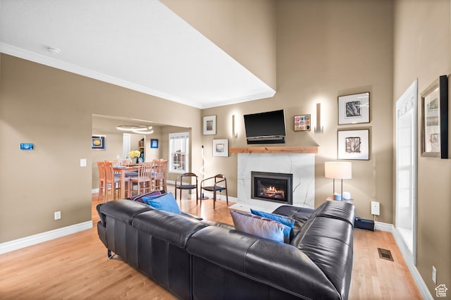 369 E 9th Ave, Salt Lake City, UT 84103 - living room featuring light wood finished floors, a high end fireplace, and ornamental molding