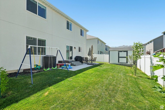 7215 N Clear Meadow Way, Eagle Mountain, UT 84005 - back of house featuring a patio area, a fenced backyard, a shed, stucco siding, and a residential view