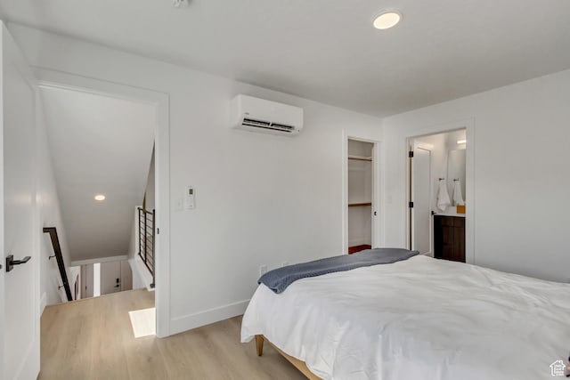 4186 S Main St Unit O217, Millcreek, UT 84107 - bedroom with a wall mounted AC, light wood-style flooring, and ensuite bathroom