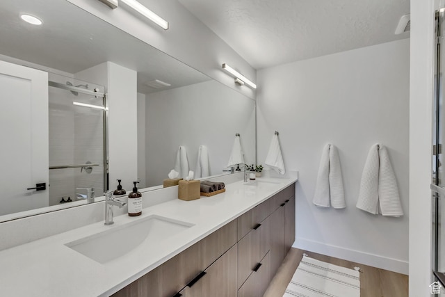 4186 S Main St Unit O217, Millcreek, UT 84107 - full bathroom with double vanity, an enclosed shower, and wood finished floors
