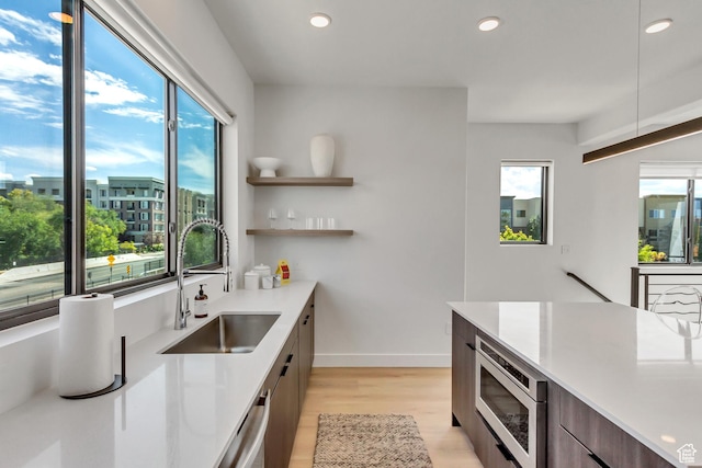 4186 S Main St Unit O217, Millcreek, UT 84107 - kitchen featuring modern cabinets, stainless steel appliances, light wood-type flooring, light countertops, and recessed lighting