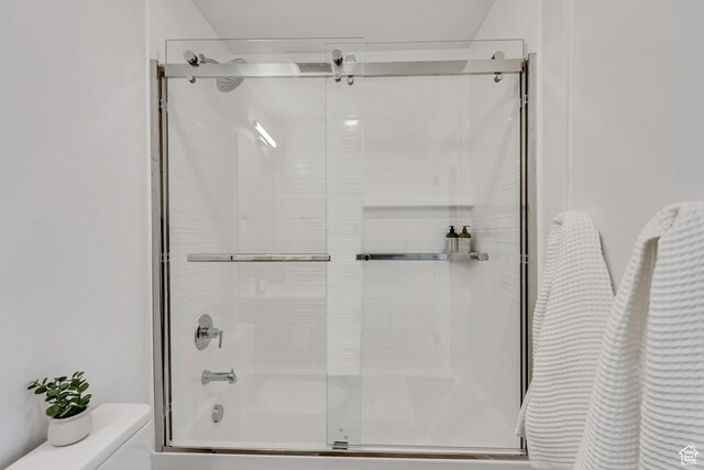 4186 S Main St Unit O217, Millcreek, UT 84107 - bathroom featuring toilet and bath / shower combo with glass door