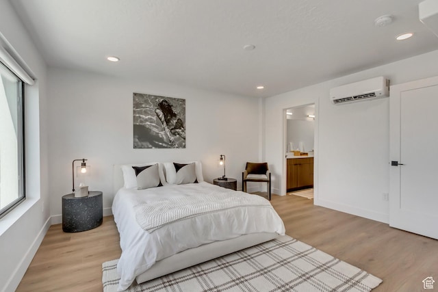 4186 S Main St Unit O217, Millcreek, UT 84107 - bedroom with a wall mounted air conditioner, light wood-style flooring, recessed lighting, and ensuite bathroom