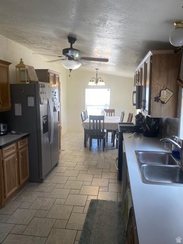 165 S 200th Ct W, Vernal, UT 84078 - kitchen featuring stainless steel refrigerator with ice dispenser, a ceiling fan, range, lofted ceiling, and a textured ceiling